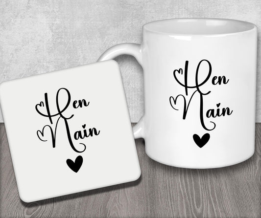 a couple of white coffee mugs sitting on top of a wooden table