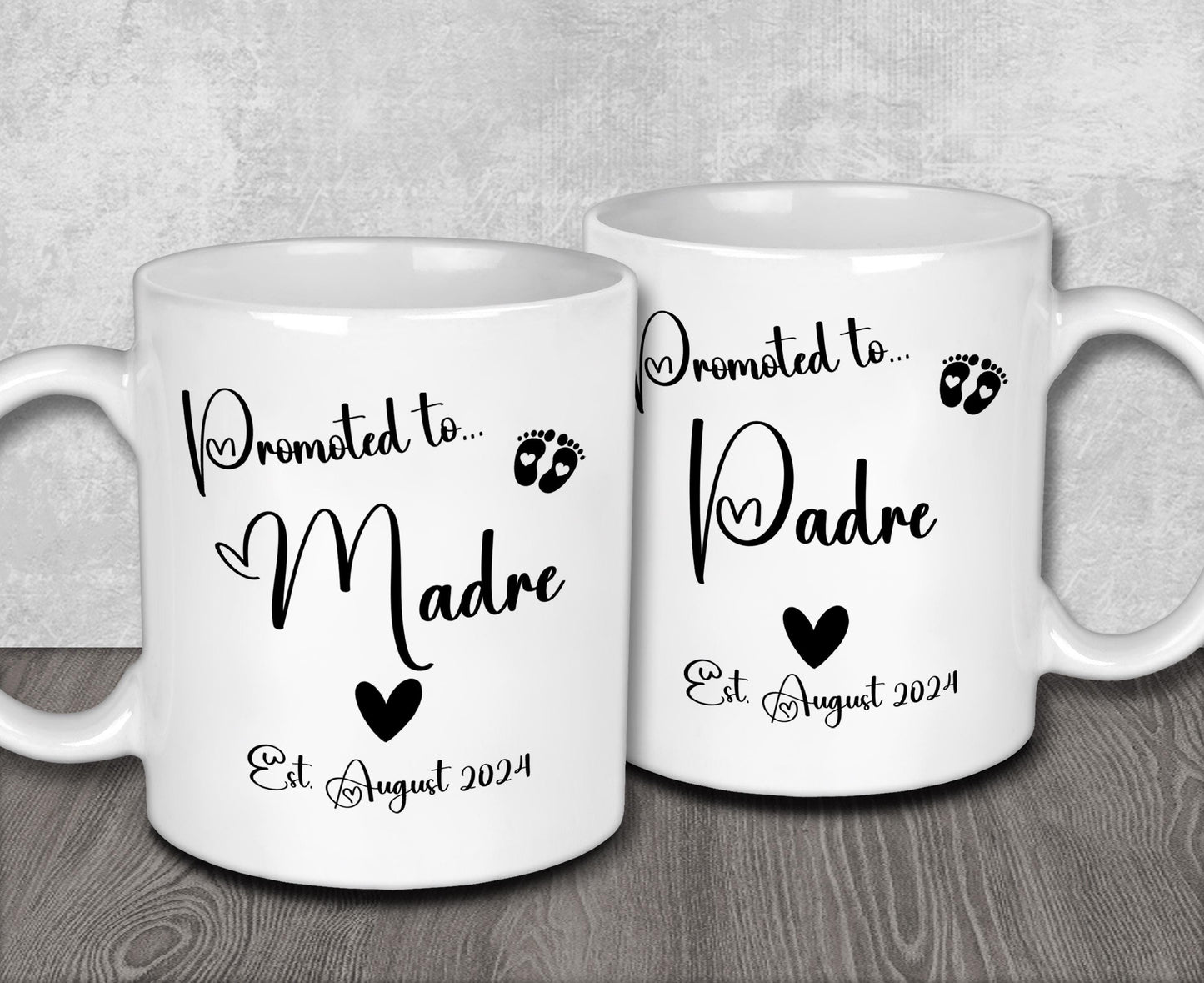 two white coffee mugs sitting on top of a wooden table