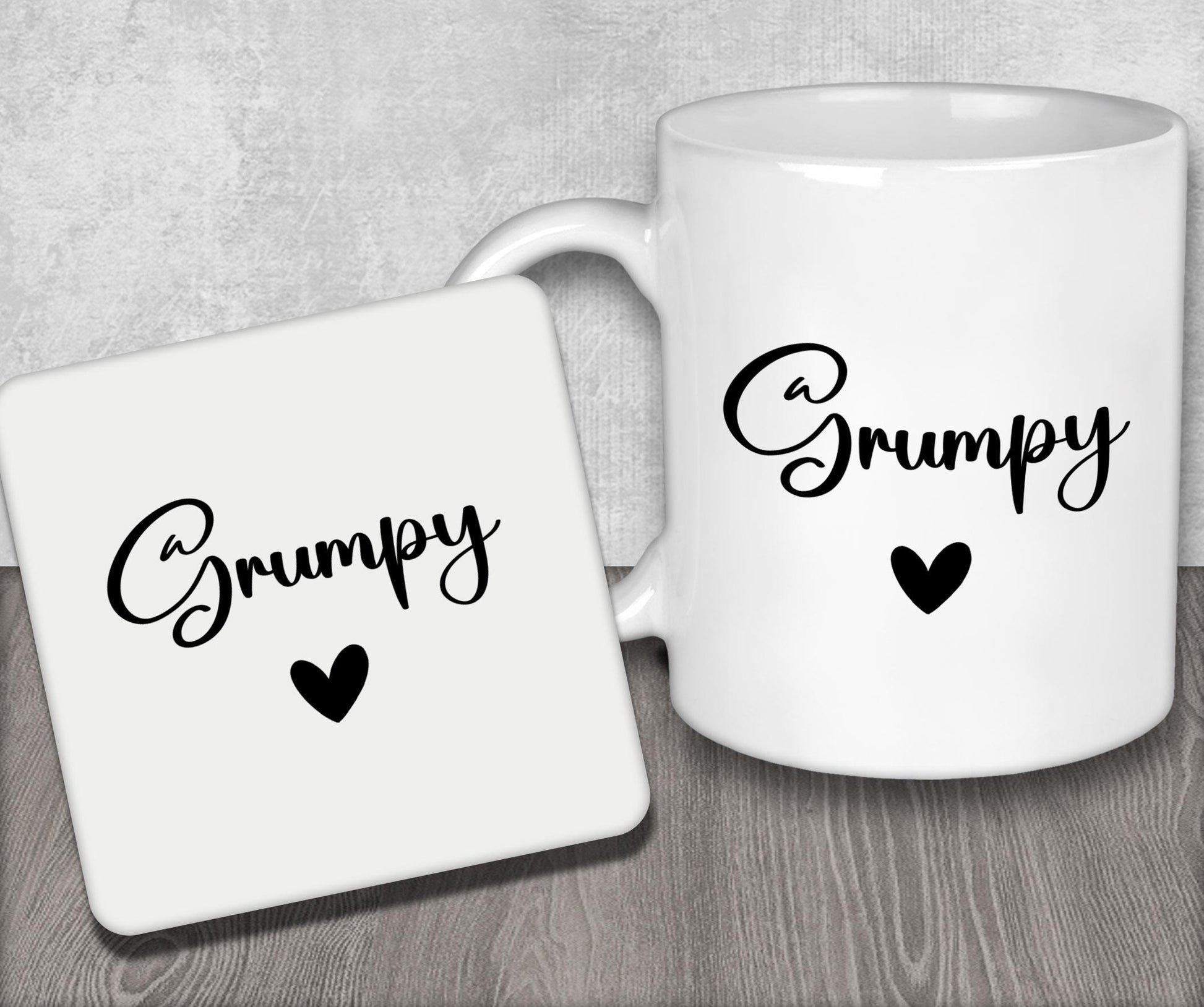 a couple of white coffee mugs sitting on top of a wooden table