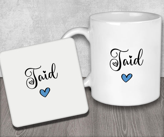 a couple of white coffee mugs sitting on top of a wooden table