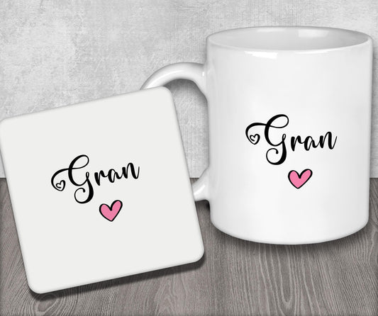 a couple of white coffee mugs sitting on top of a wooden table