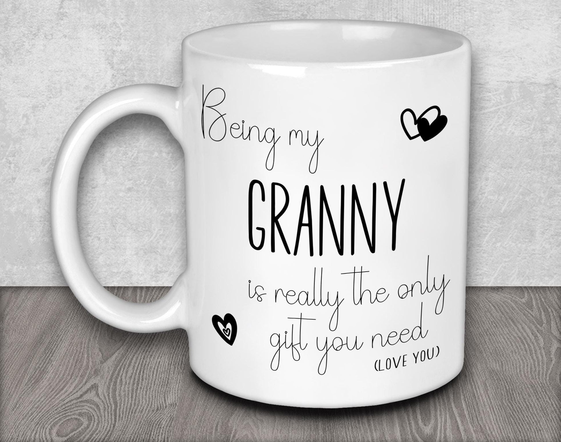 a white coffee mug with the words, being my granny is really the only gift