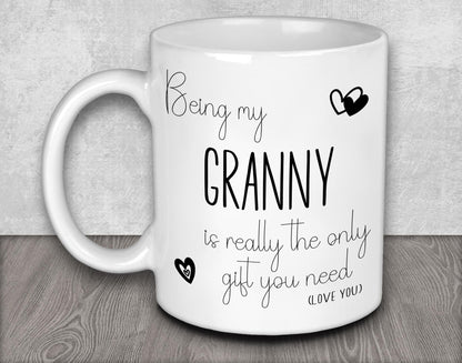 a white coffee mug with the words, being my granny is really the only gift