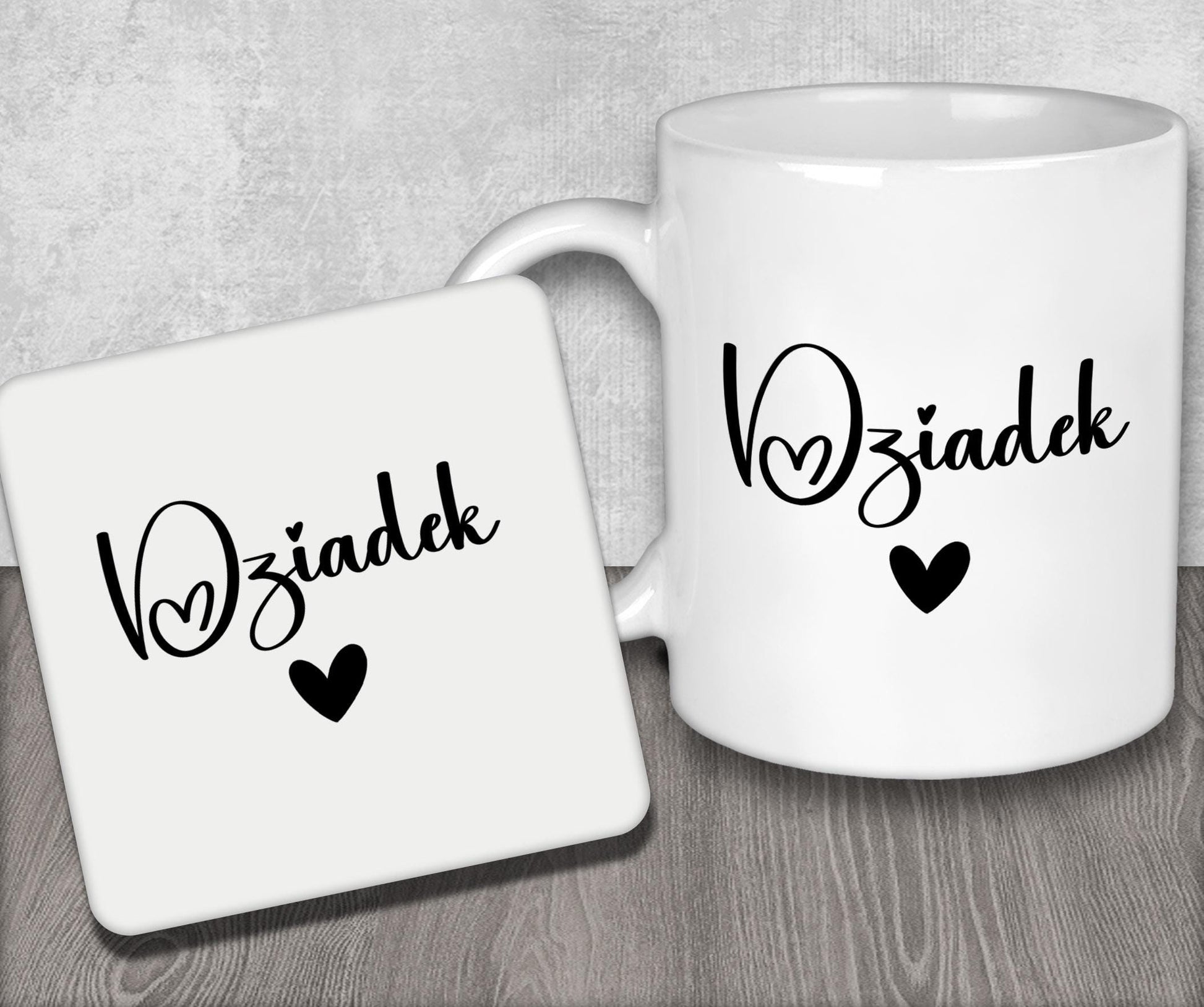 a couple of white coffee mugs sitting on top of a wooden table