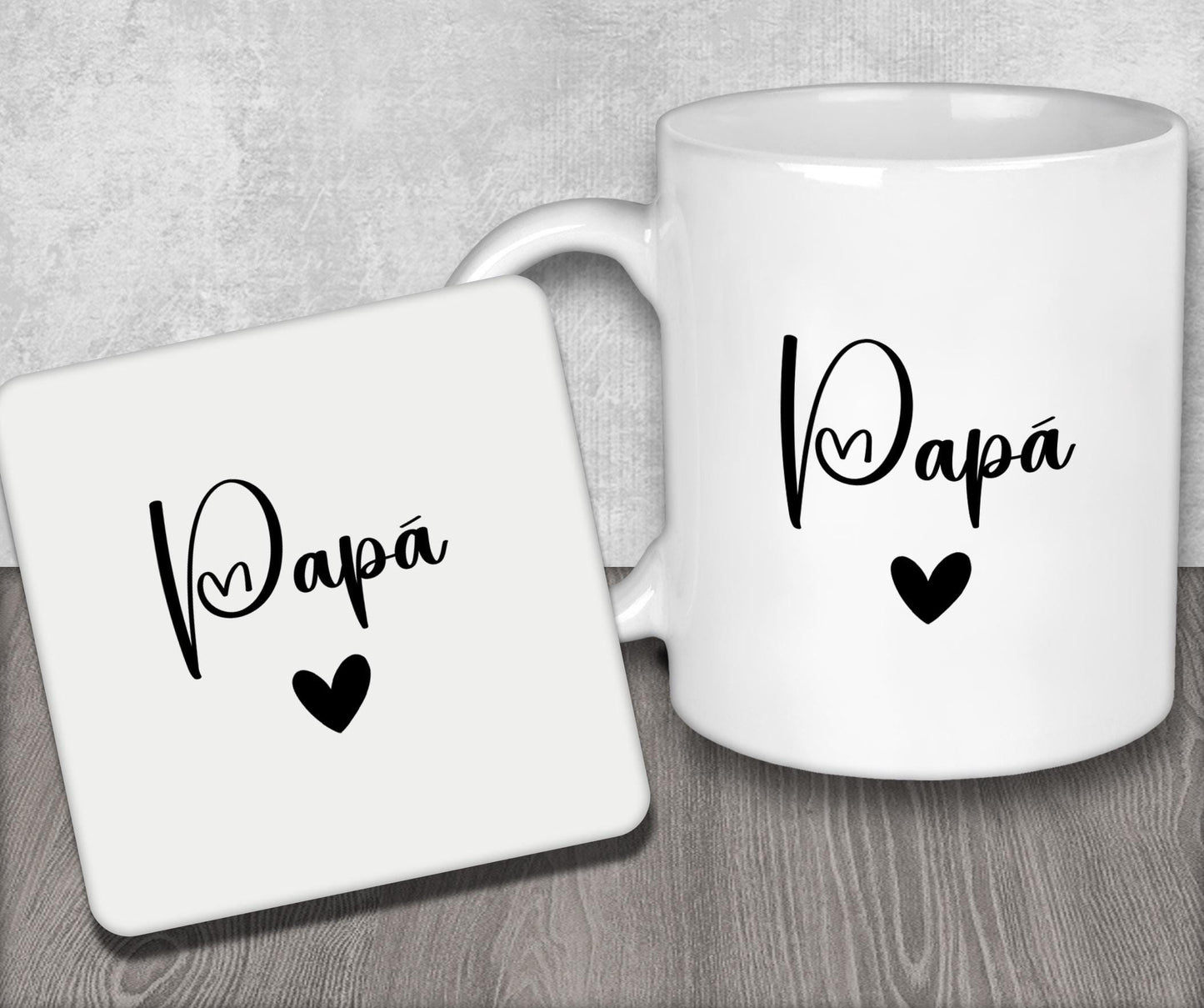 a couple of white coffee mugs sitting on top of a wooden table