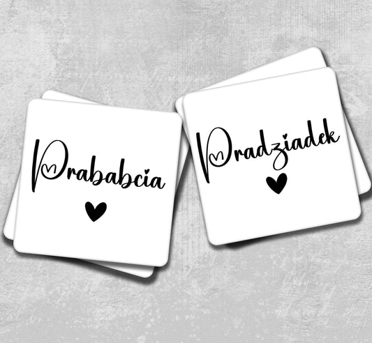 two white coasters with black lettering on them