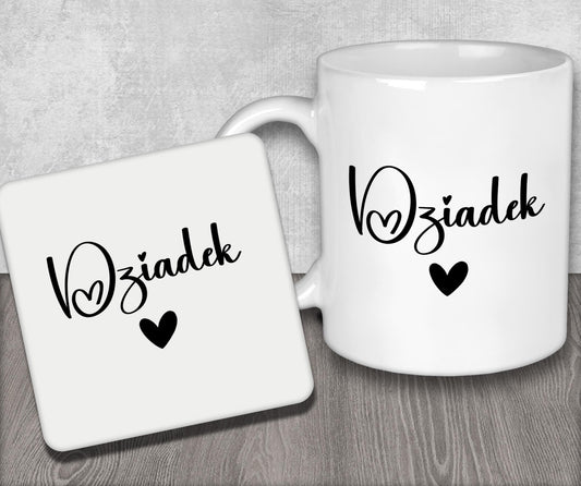 a couple of white coffee mugs sitting on top of a wooden table