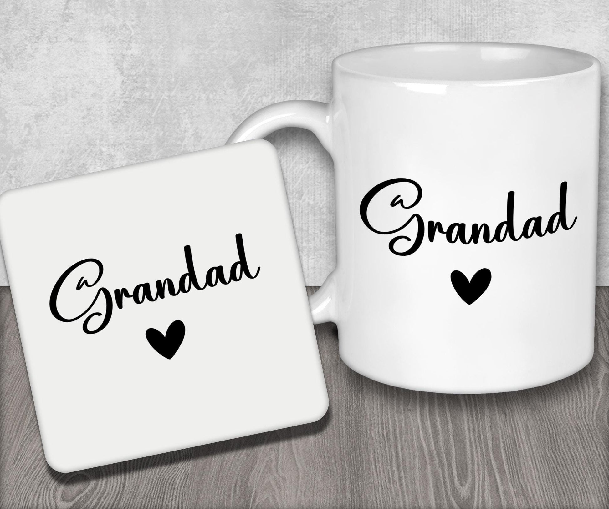 a couple of white coffee mugs sitting on top of a wooden table