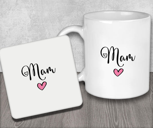 a white coffee mug with the word mom on it