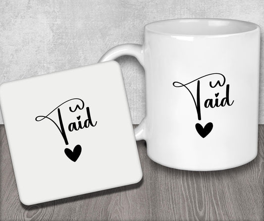 a couple of white coffee mugs sitting on top of a wooden table