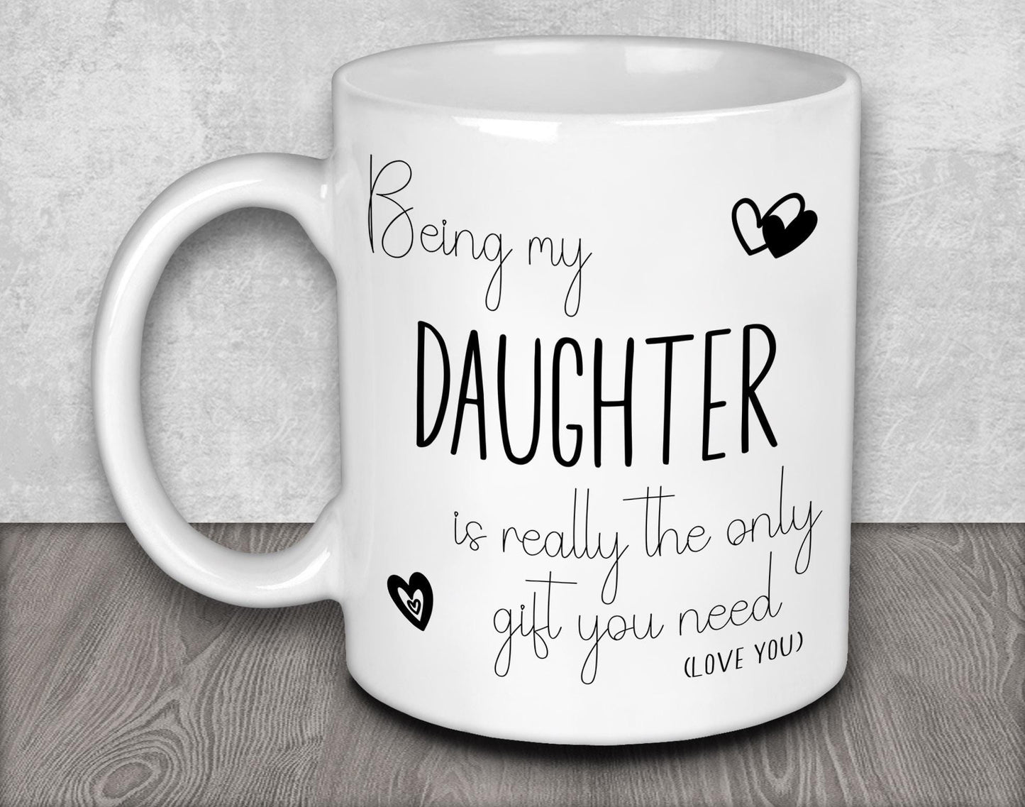 a white coffee mug with the words being my daughter is really the only gift you