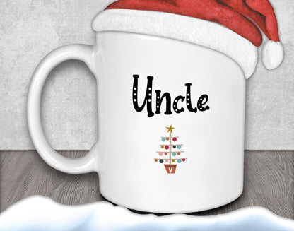 A white mug with the word &quot;Uncle&quot; printed on it, along with a Christmas tree design.