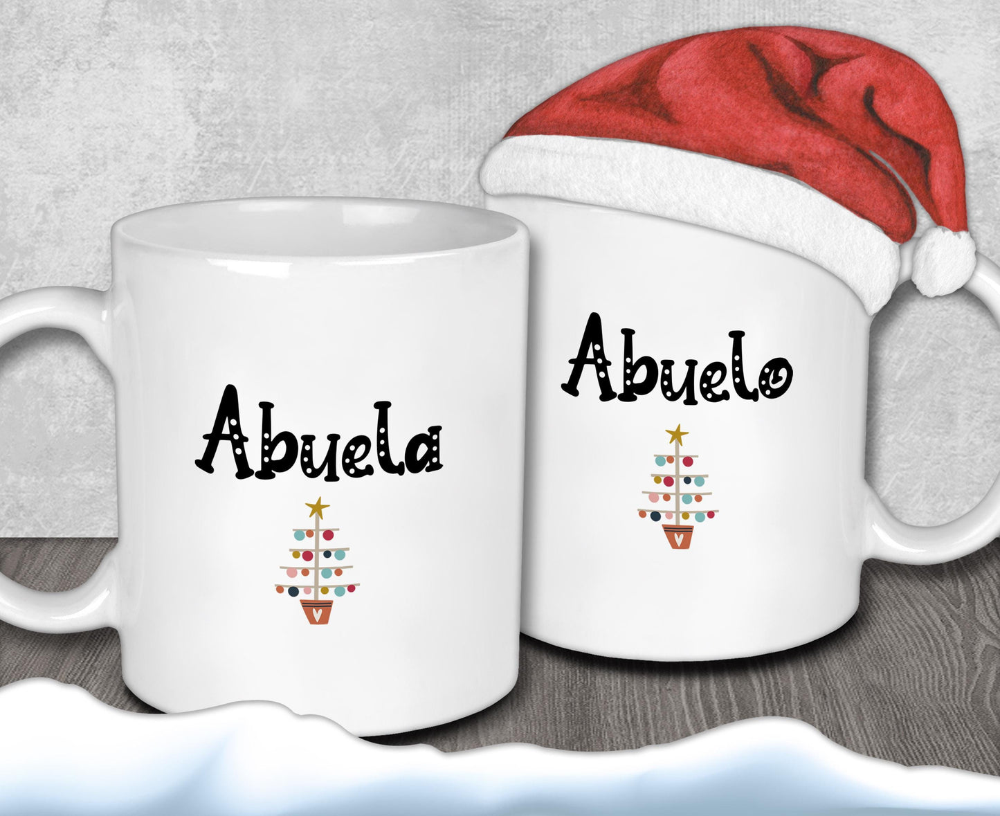 Two white mugs with the word &quot;Abuela&quot; printed on them, along with a red Santa hat.
