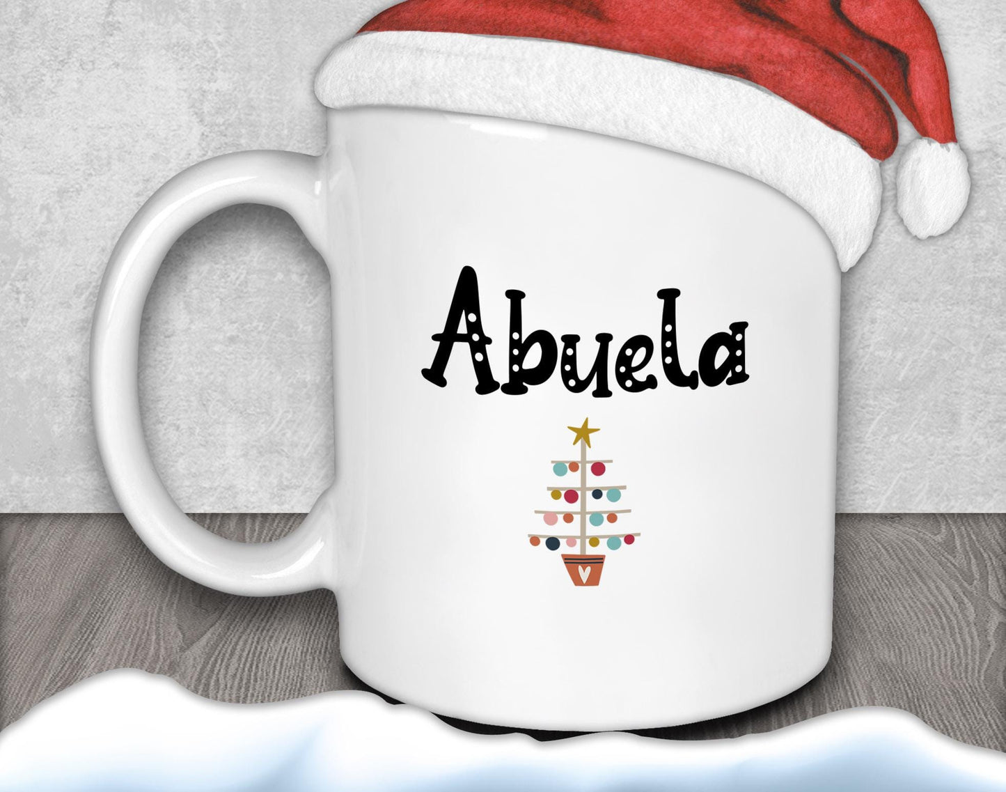 A white mug with the word &quot;Abuela&quot; printed on it, along with a Christmas tree design.