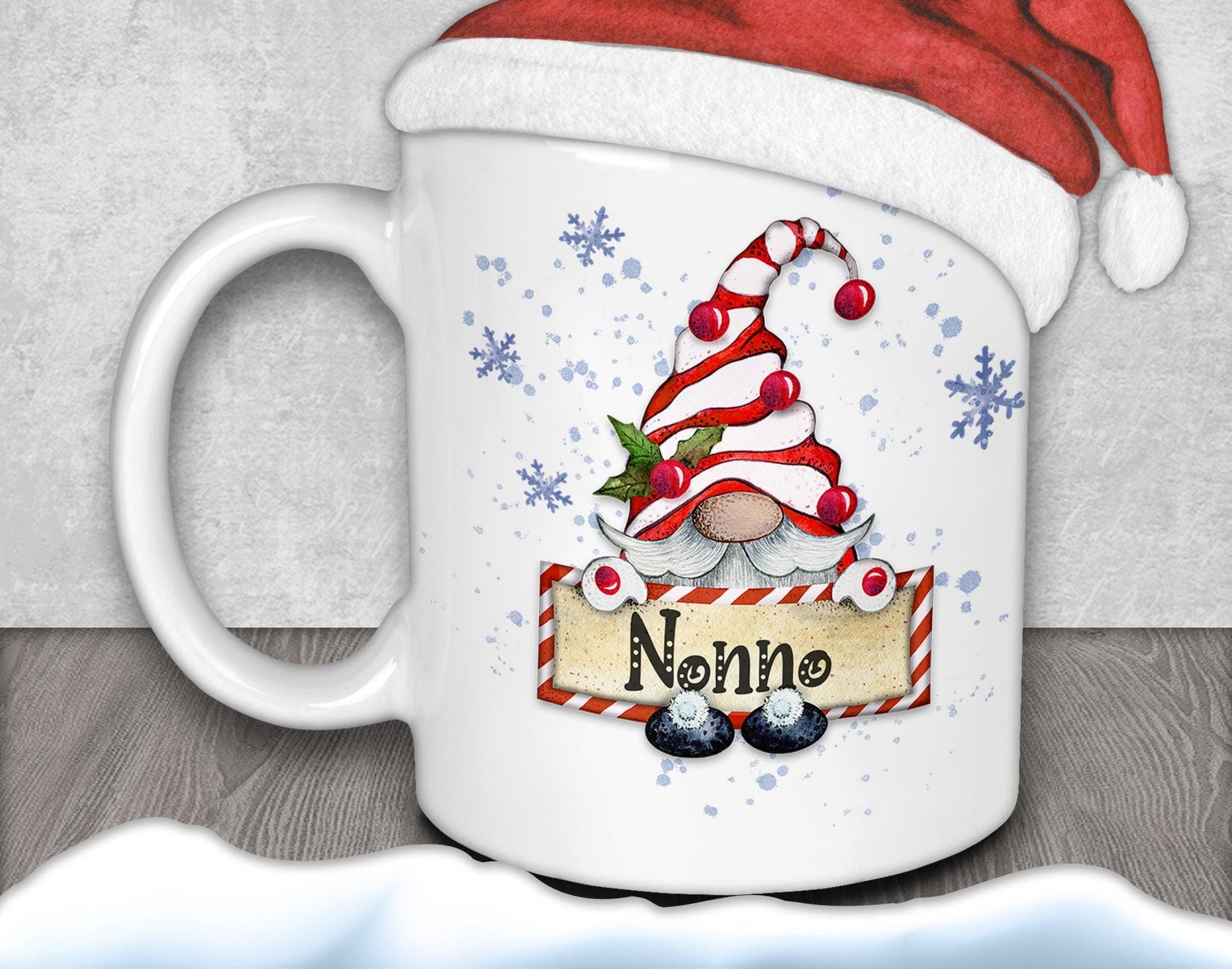 A mug with a gnome design and a Santa hat on top, along with snowflakes and the word "Nonna" written on it.