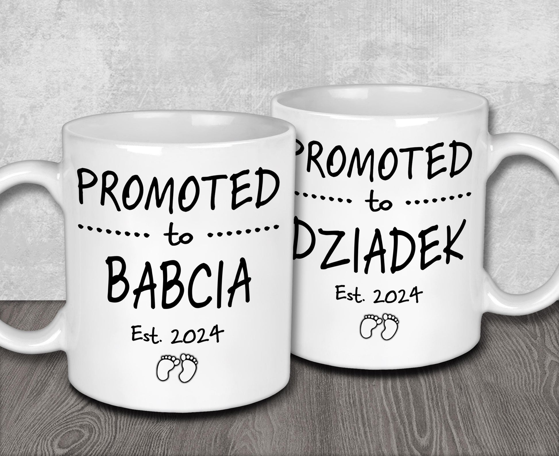 two white coffee mugs sitting on top of a wooden table