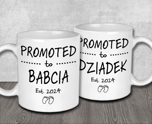 two white coffee mugs sitting on top of a wooden table