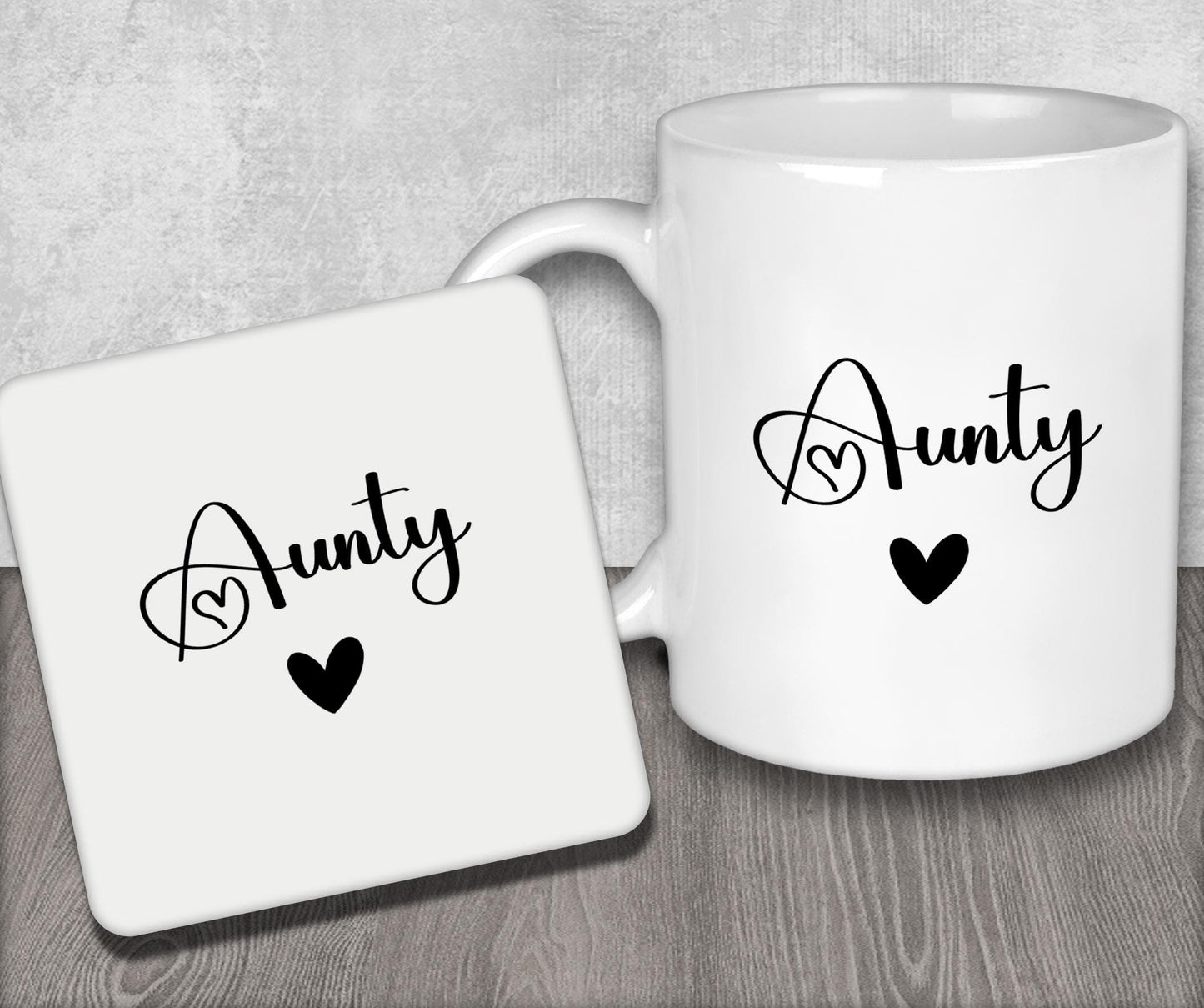 a couple of white coffee mugs sitting on top of a wooden table