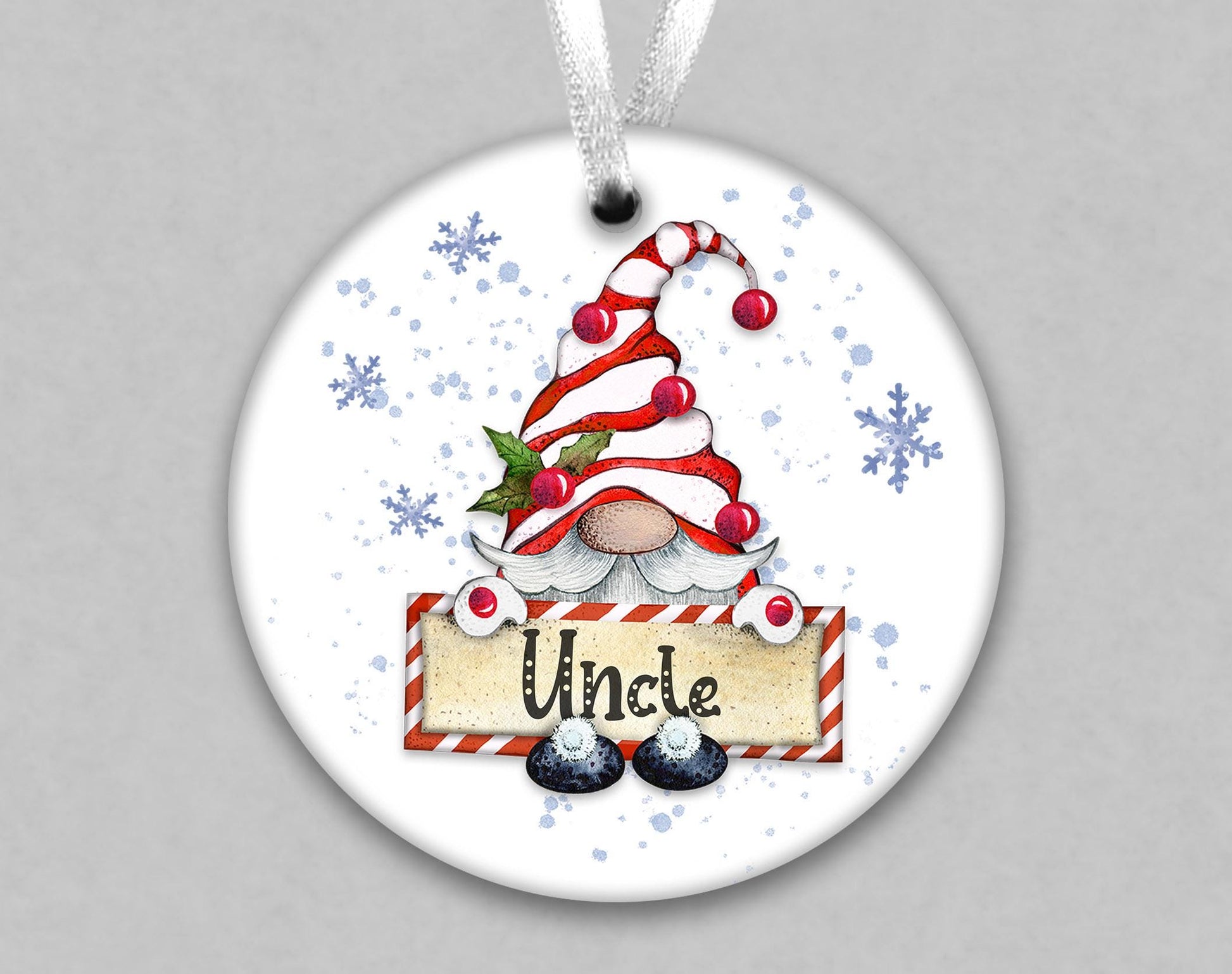 A white ornament with a gnome-like figure wearing a red and white striped hat and holding a sign that says &quot;Uncle&quot;.