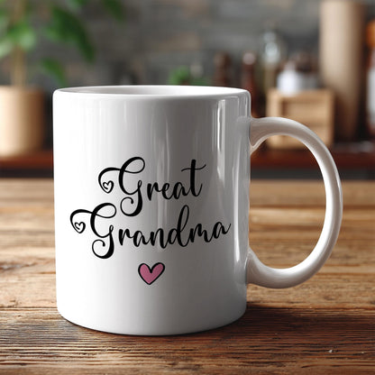 A white ceramic mug with the text "Great Grandma" and a heart symbol printed on it, placed on a wooden surface.