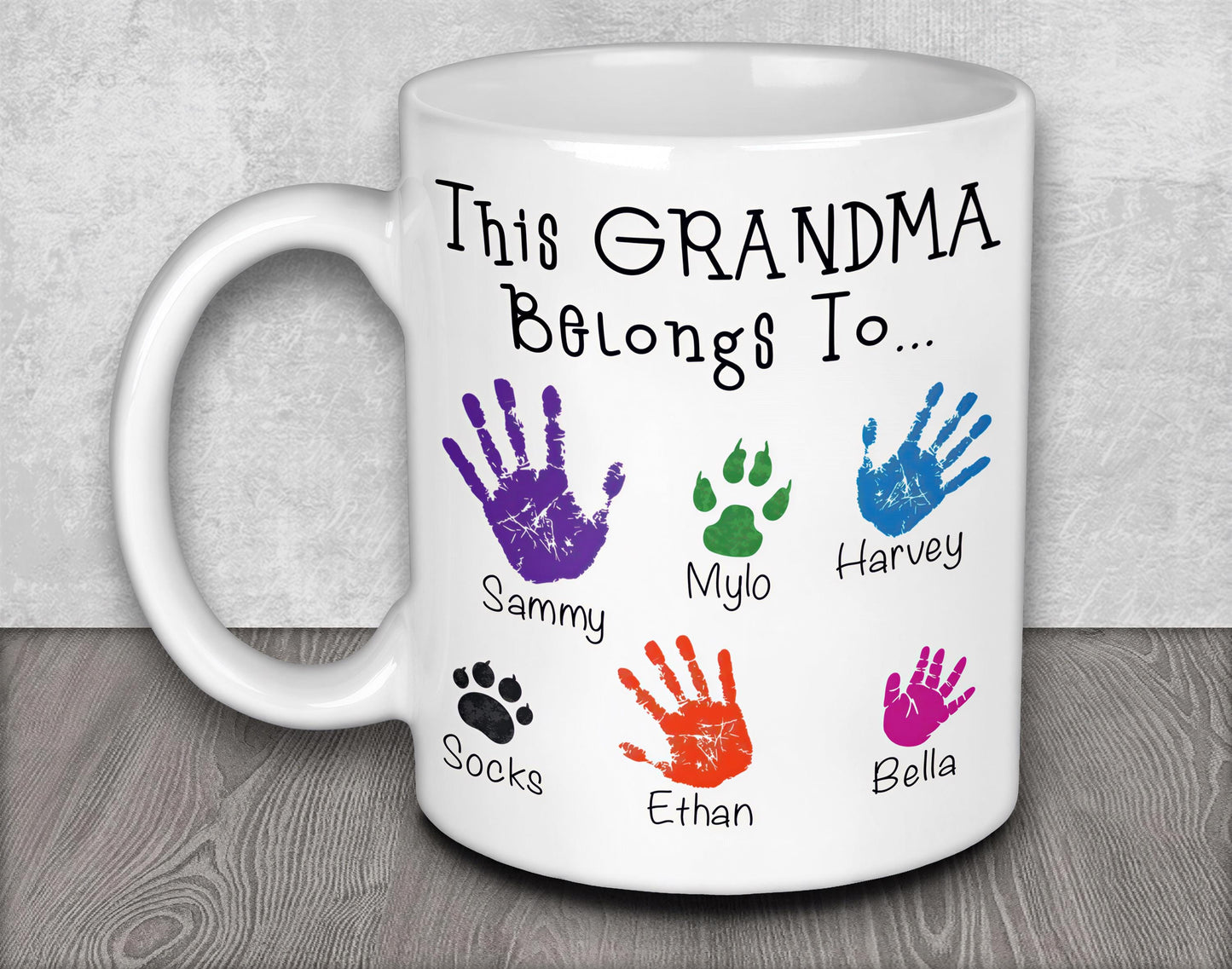 a white coffee mug with a handprinted picture of a dog's paw