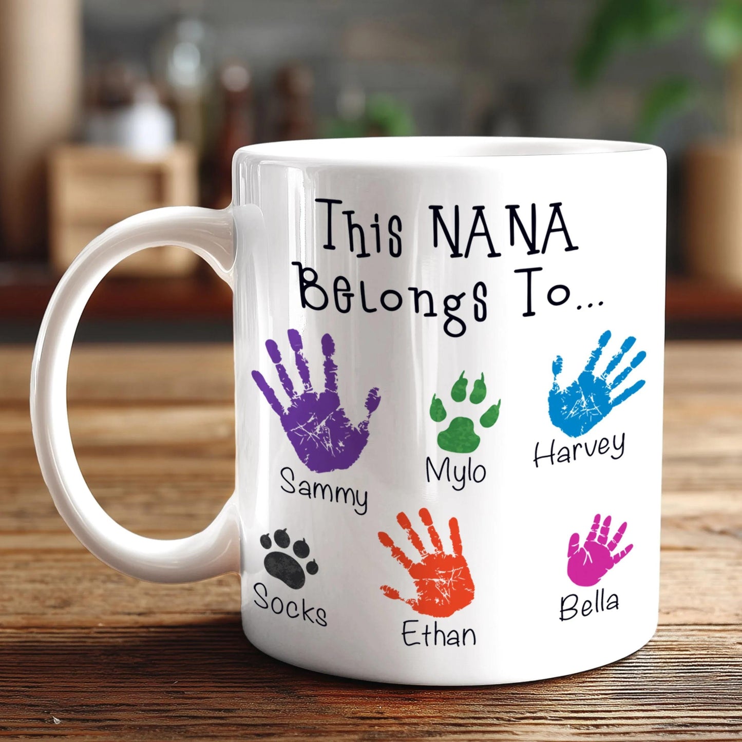A white mug with a personalized message and handprint designs on it.