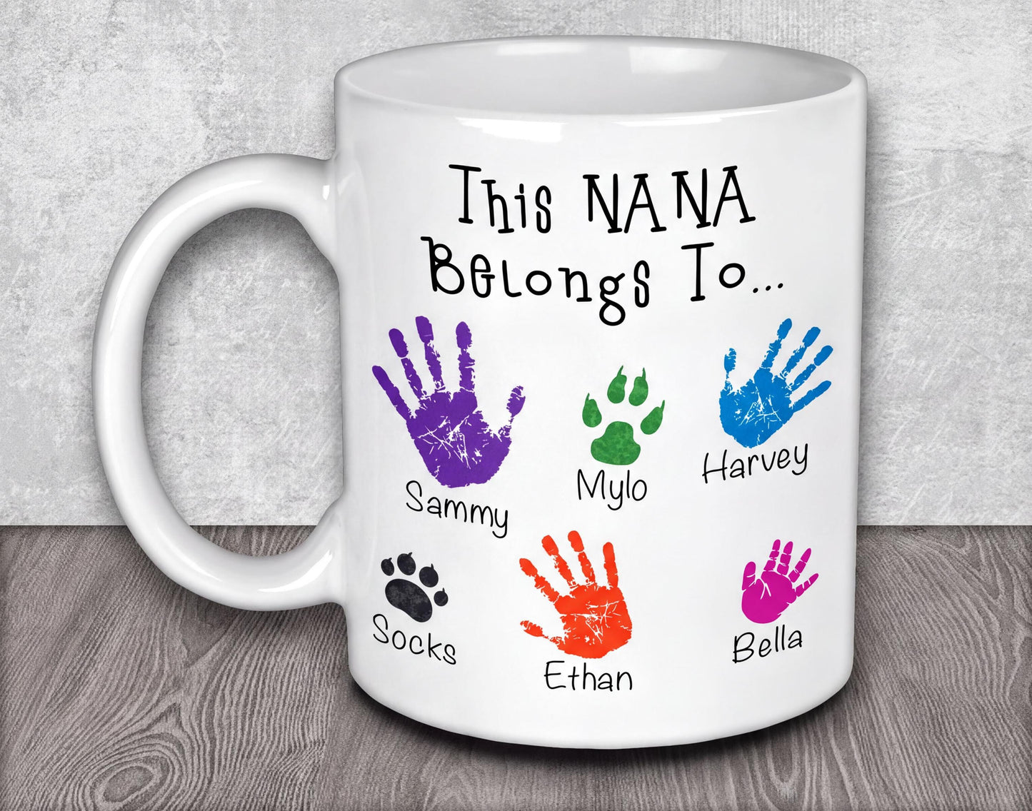 a white coffee mug with colorful hand prints on it