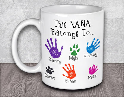 a white coffee mug with colorful hand prints on it