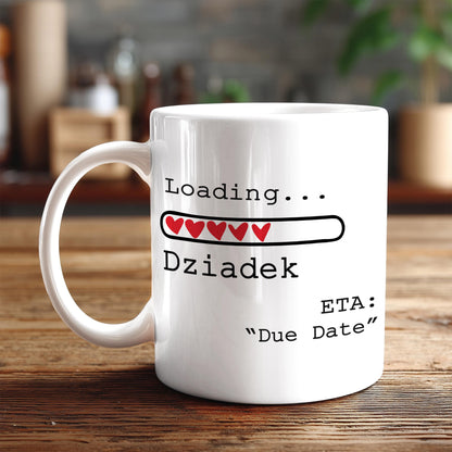 A white coffee mug with text and graphics on it, placed on a wooden surface.