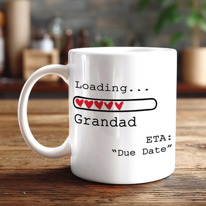 A white coffee mug with text and graphics on it, placed on a wooden surface.