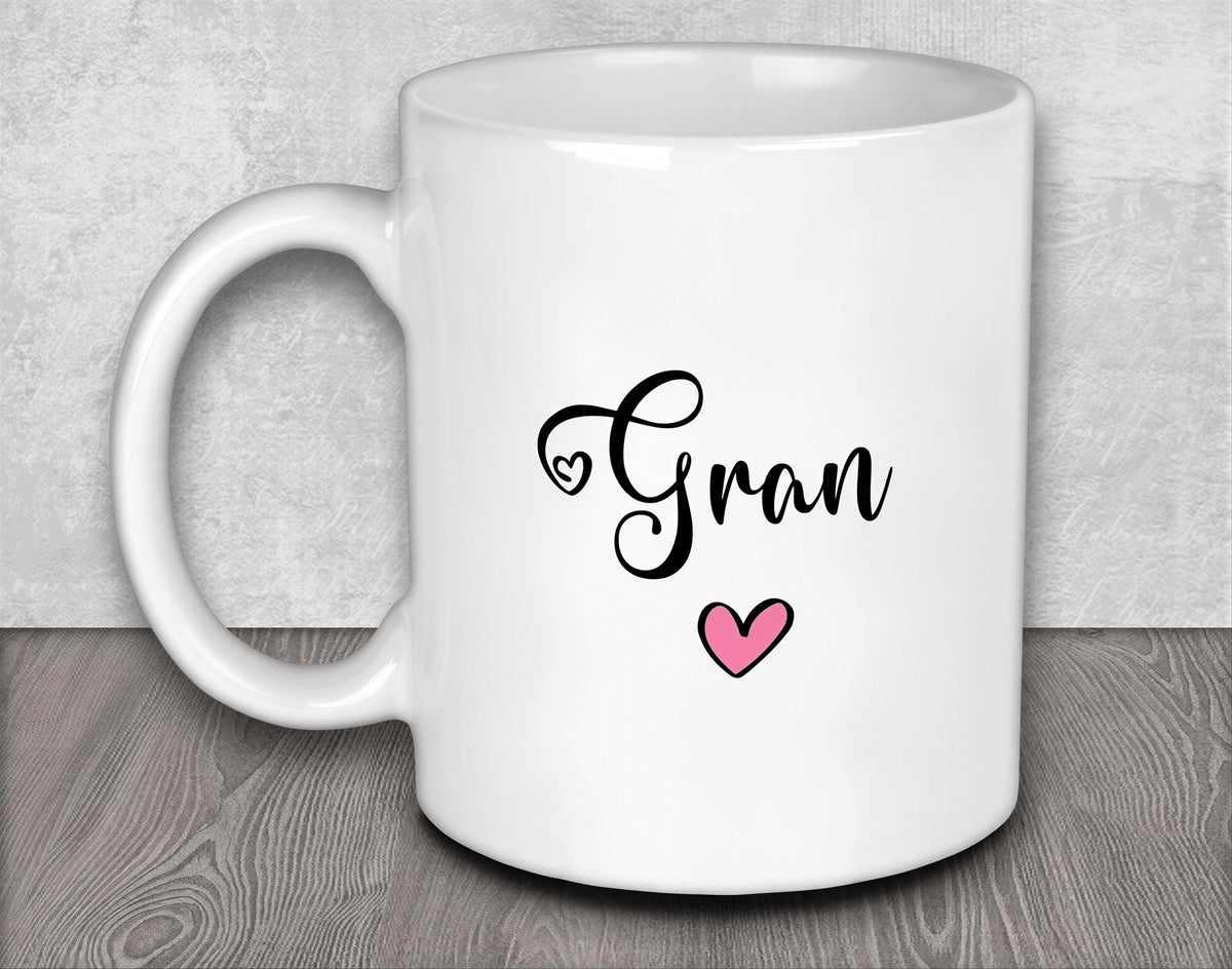 a white coffee mug with a pink heart on it
