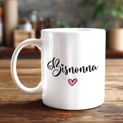 A white ceramic mug with the word "Bisnonna" written on it, along with a small pink heart symbol.