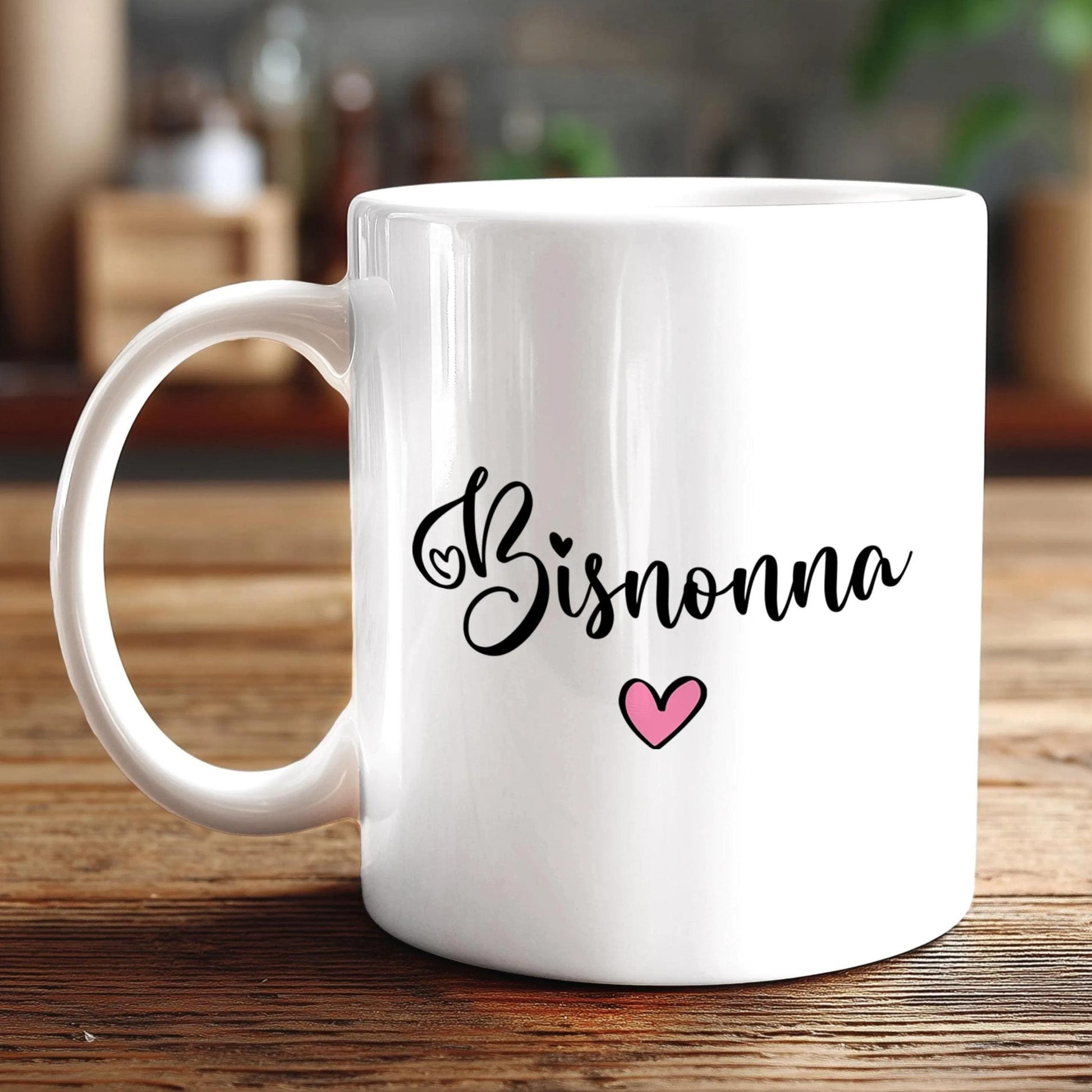 A white ceramic mug with the word "Bisnonna" written on it, along with a small pink heart symbol.