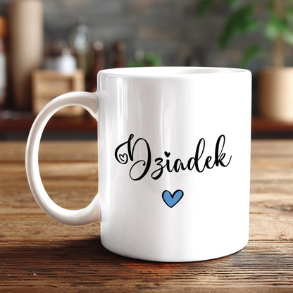 A white ceramic mug with the word "Oziaek" written on it in a cursive font, along with a small blue heart symbol.