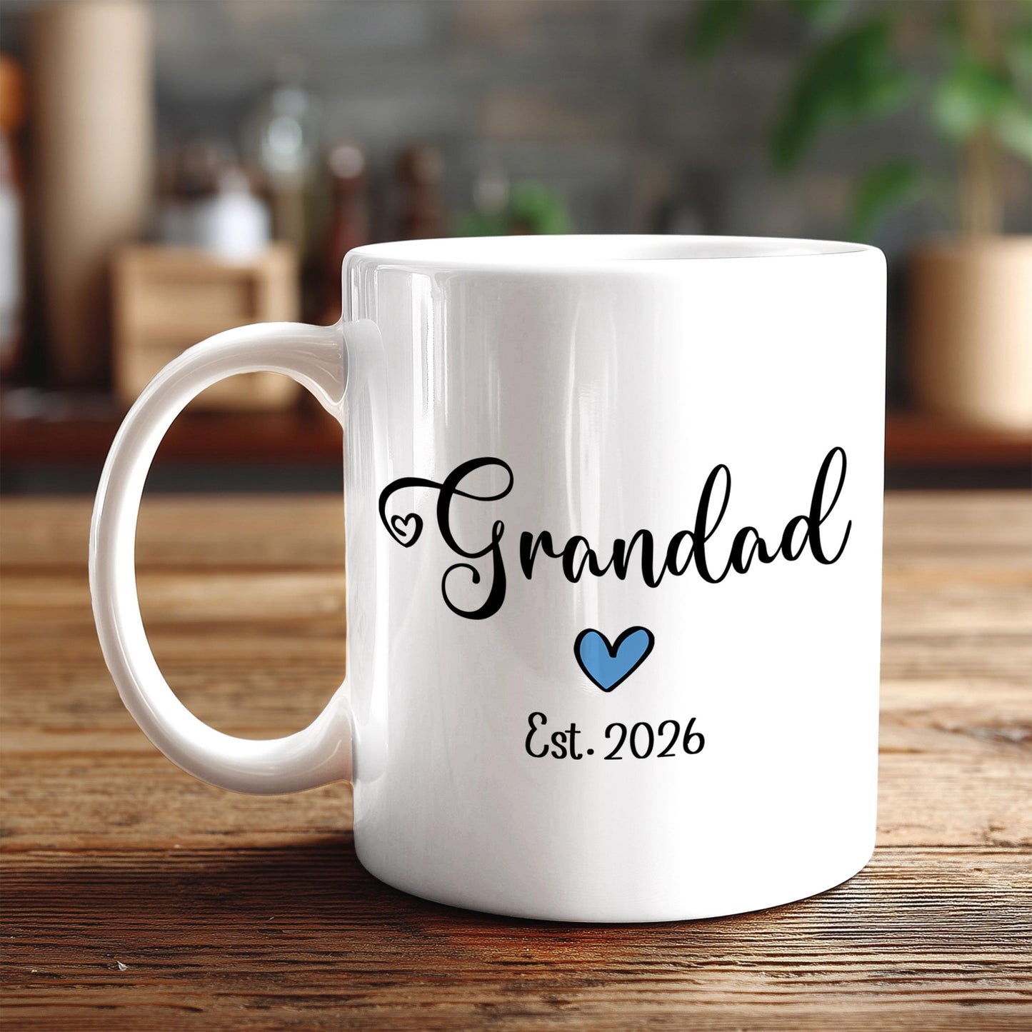 A white ceramic mug with the text "Grandad" and "Est. 2026" printed on it, along with a blue heart symbol.