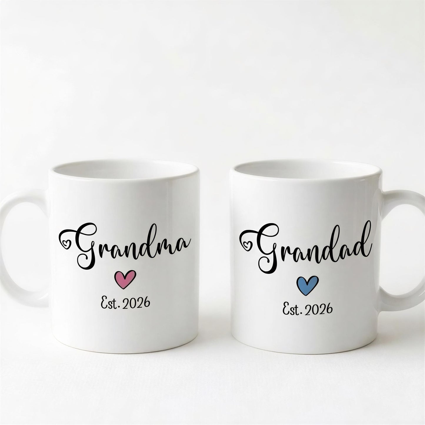 Two white ceramic mugs with the text "Grandma" and "Grandpa" printed on them, along with the year "Est. 2026" below the text.