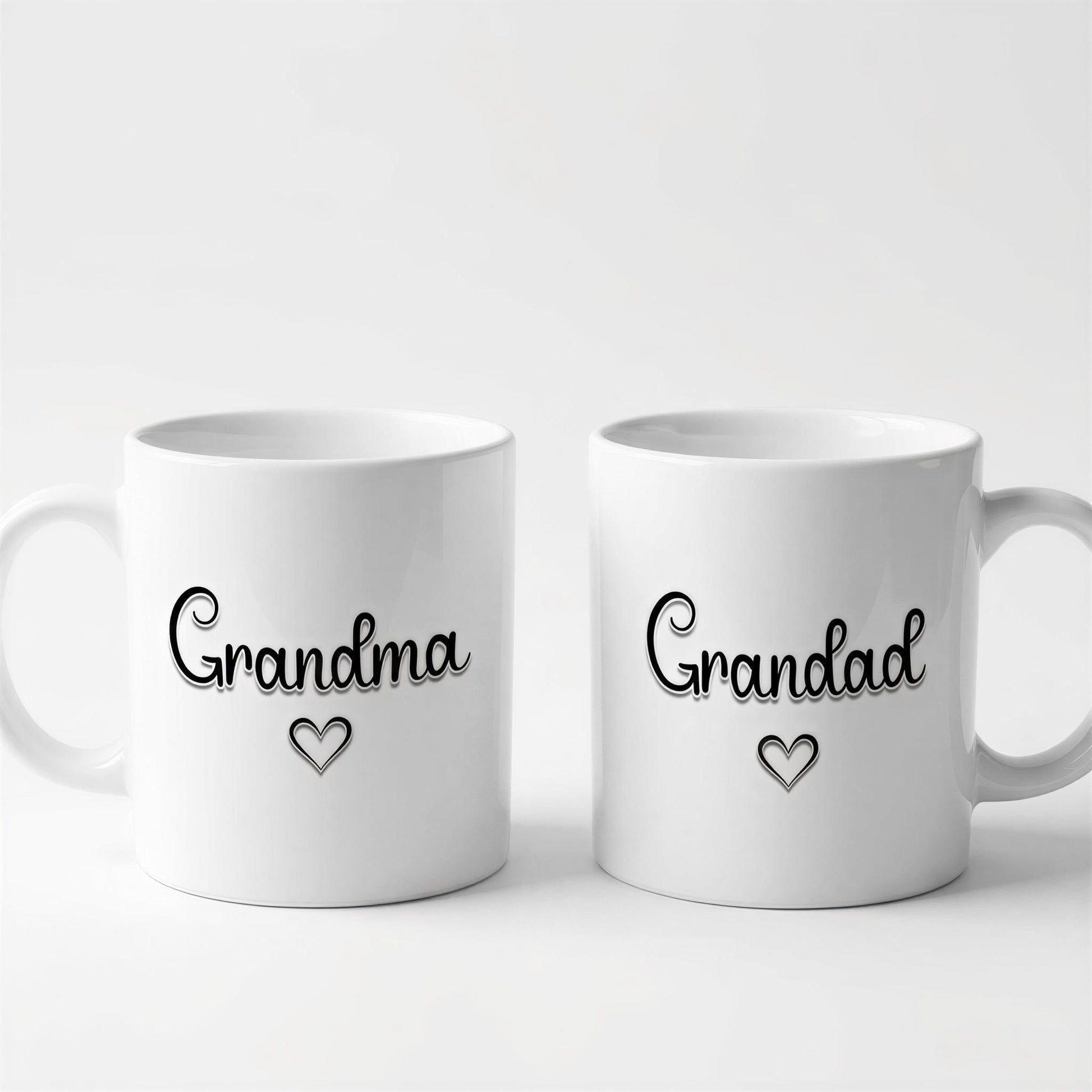 Two white ceramic mugs with the text "Grandma" and "Granddad" printed on them, along with a heart symbol.