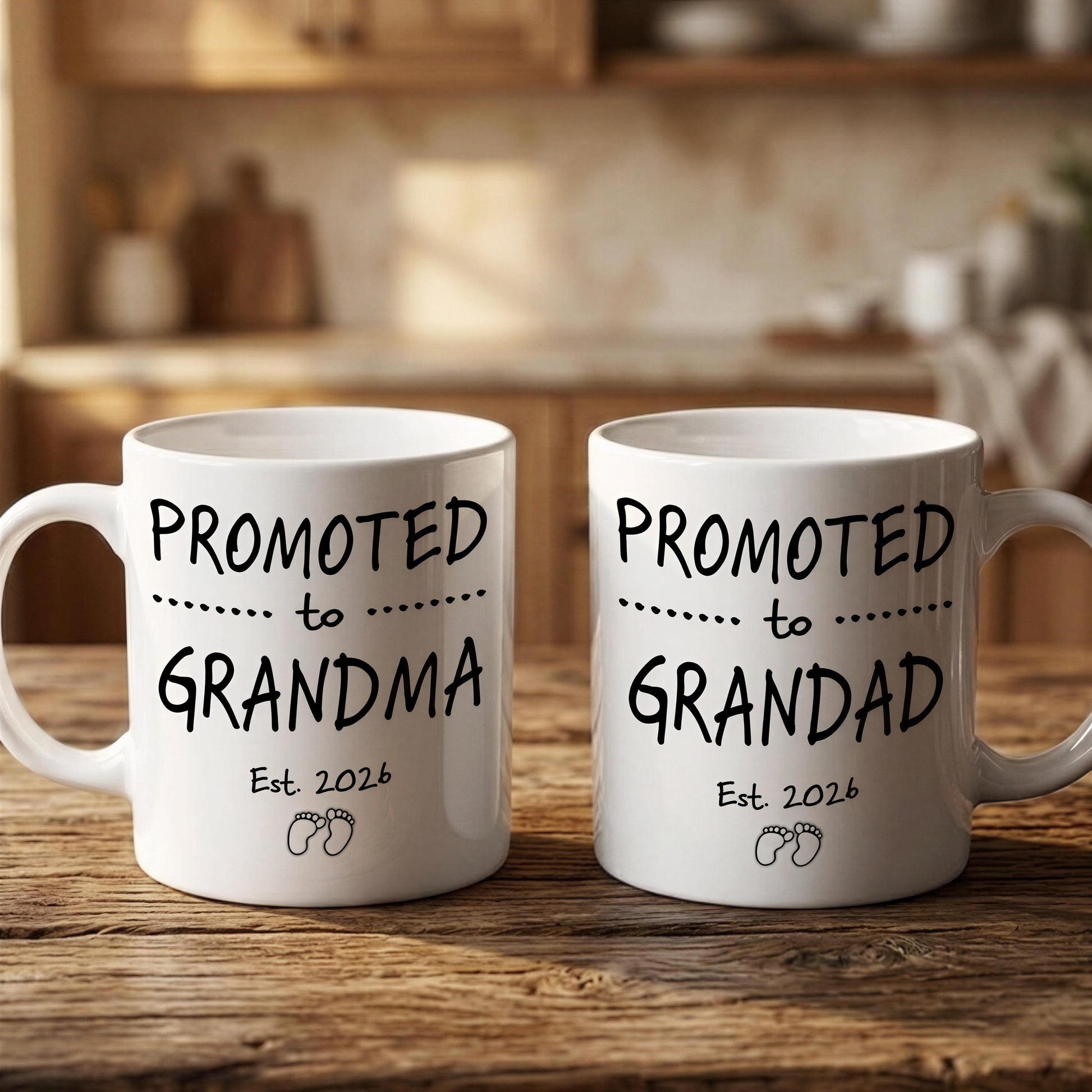 Two white ceramic mugs with black text that reads "PROMOTED TO GRANDMA Est. 2026" and "PROMOTED TO GRANDDAD Est. 2026" respectively.