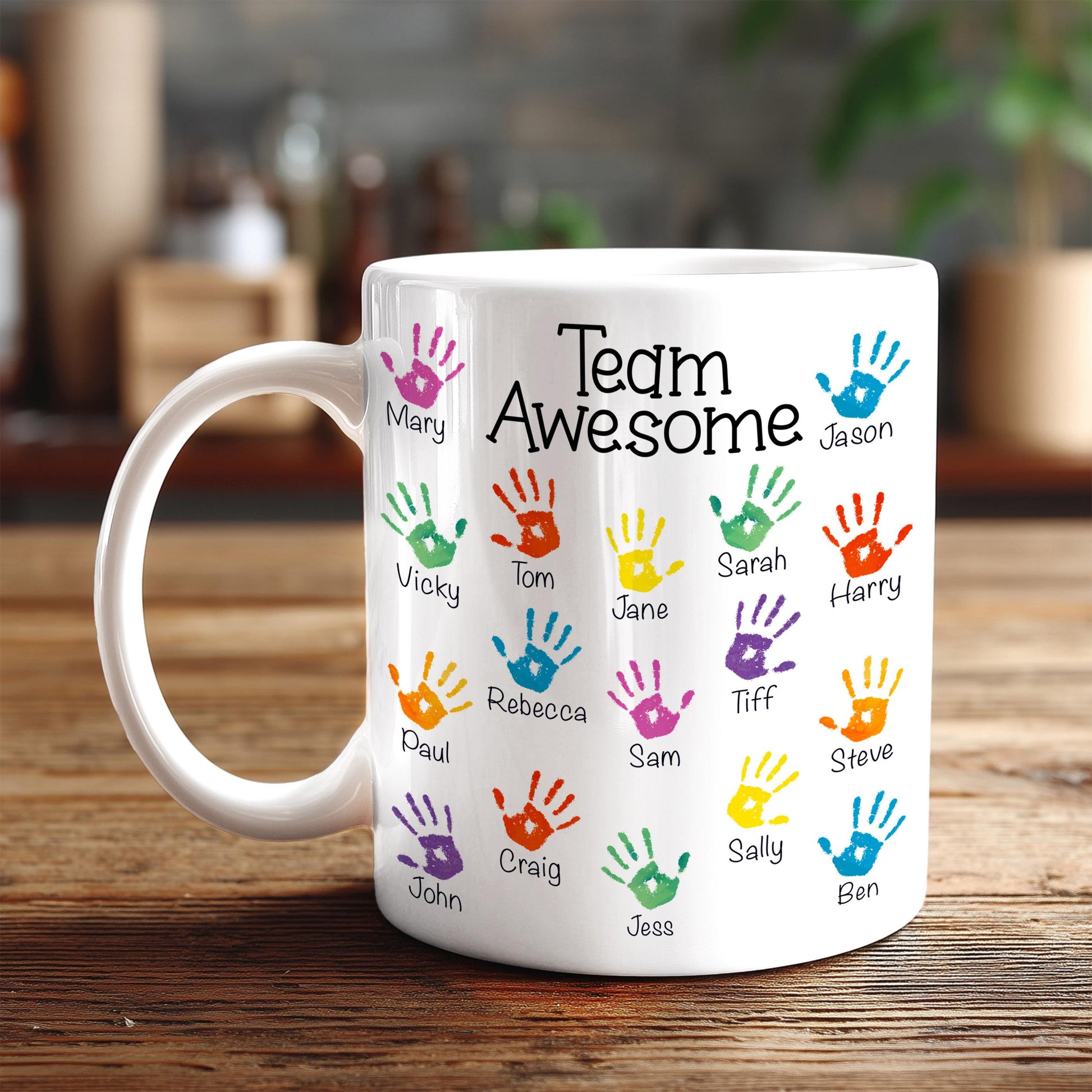 A white mug with colorful handprints on it, each containing a name.