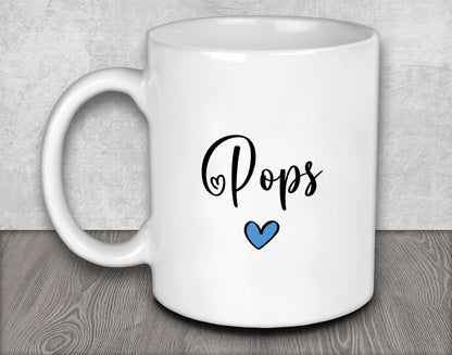 a white coffee mug with the word pops on it