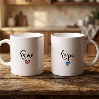 Two white mugs with the text "Oma" and "Opa" printed on them, along with heart symbols, are placed on a wooden surface.
