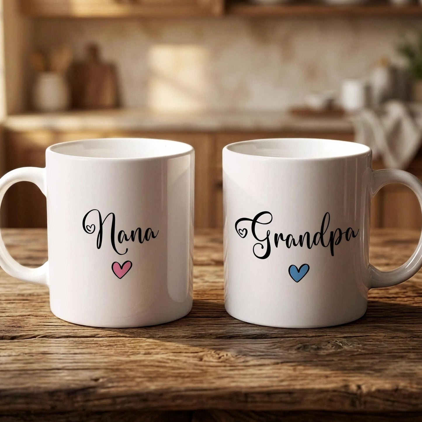 Two white mugs with the names "Nana" and "Grandpa" printed on them, along with hearts, are placed on a wooden surface.