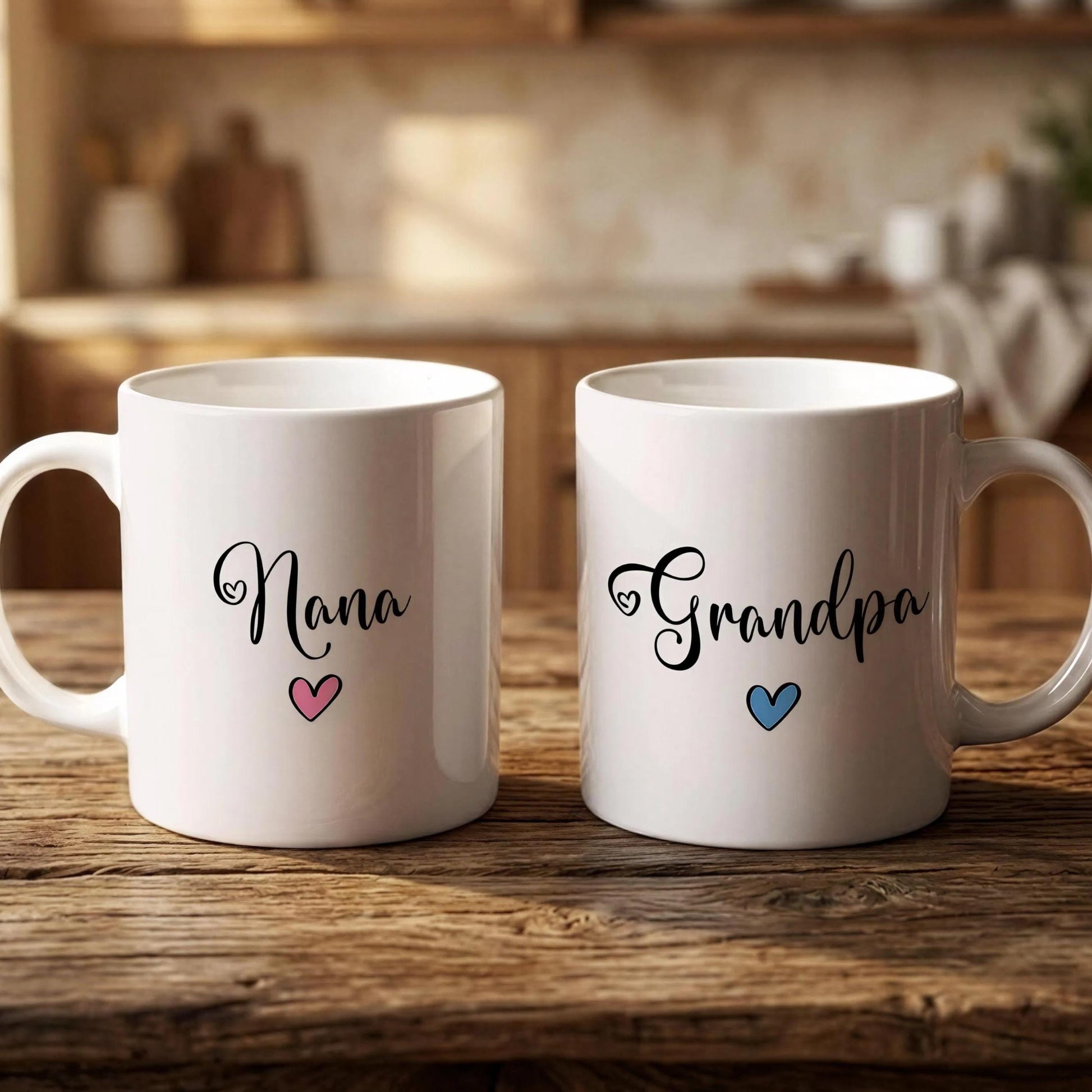 Two white mugs with the names "Nana" and "Grandpa" printed on them, along with hearts, are placed on a wooden surface.