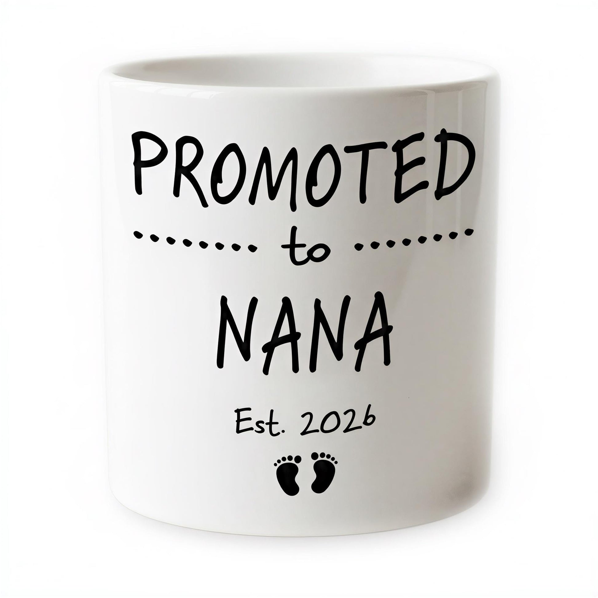 The image is a white ceramic mug with black text and footprint graphics.