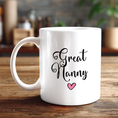 A white ceramic mug with the text "Great Nanny" printed on it, along with a small pink heart symbol.