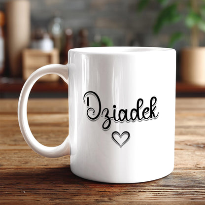 A white ceramic mug with the word "Dzia Dusk" written on it, along with a heart symbol, sits on a wooden surface.