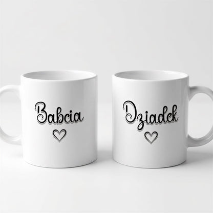 Two white ceramic mugs with black text and heart symbols on them.