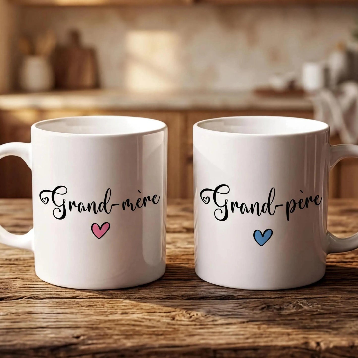 Two white mugs with the text "Grand-more" and "Grand-pire" printed on them, placed on a wooden surface.