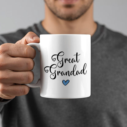 A person is holding a white mug with the text "Great Grandad" written on it.