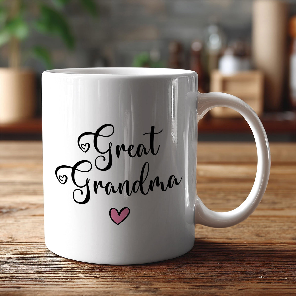 A white ceramic mug with the text "Great Grandma" and a heart symbol printed on it, placed on a wooden surface.